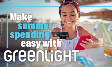 Young girl holding Greenlight card
